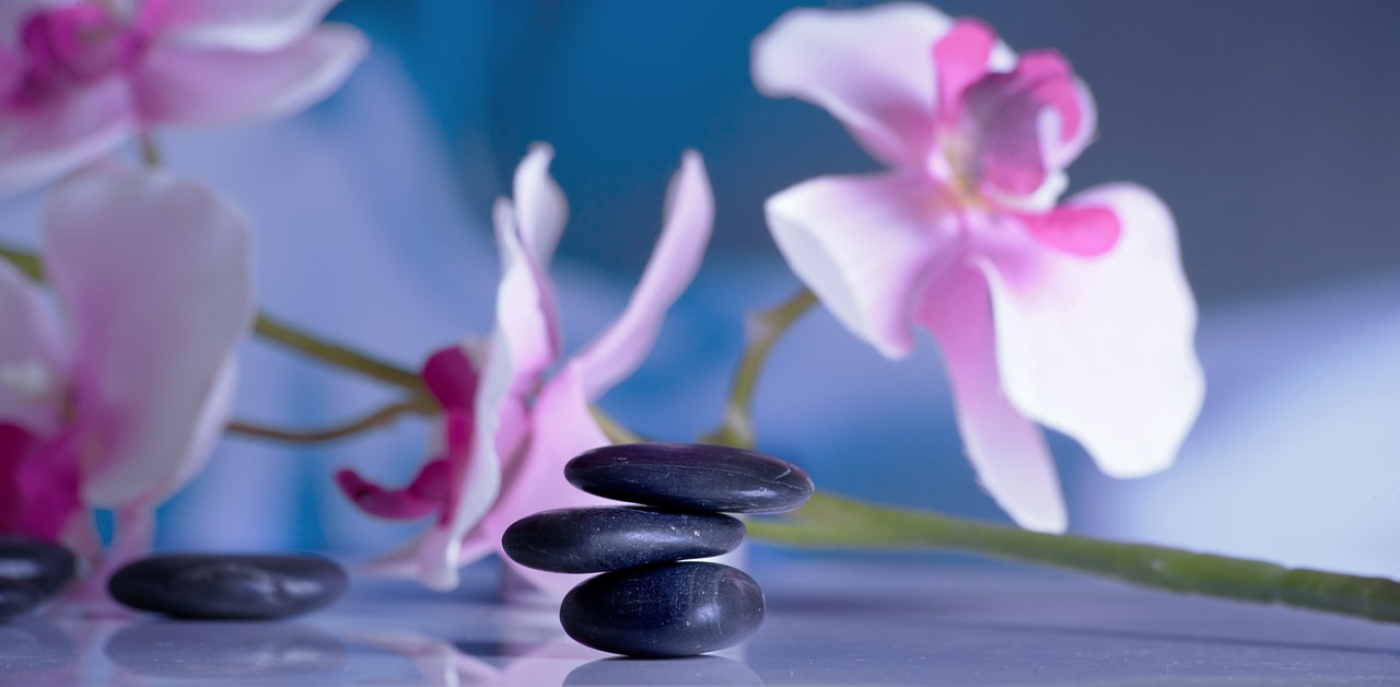 Spa-like wellness image with stacked massage rocks